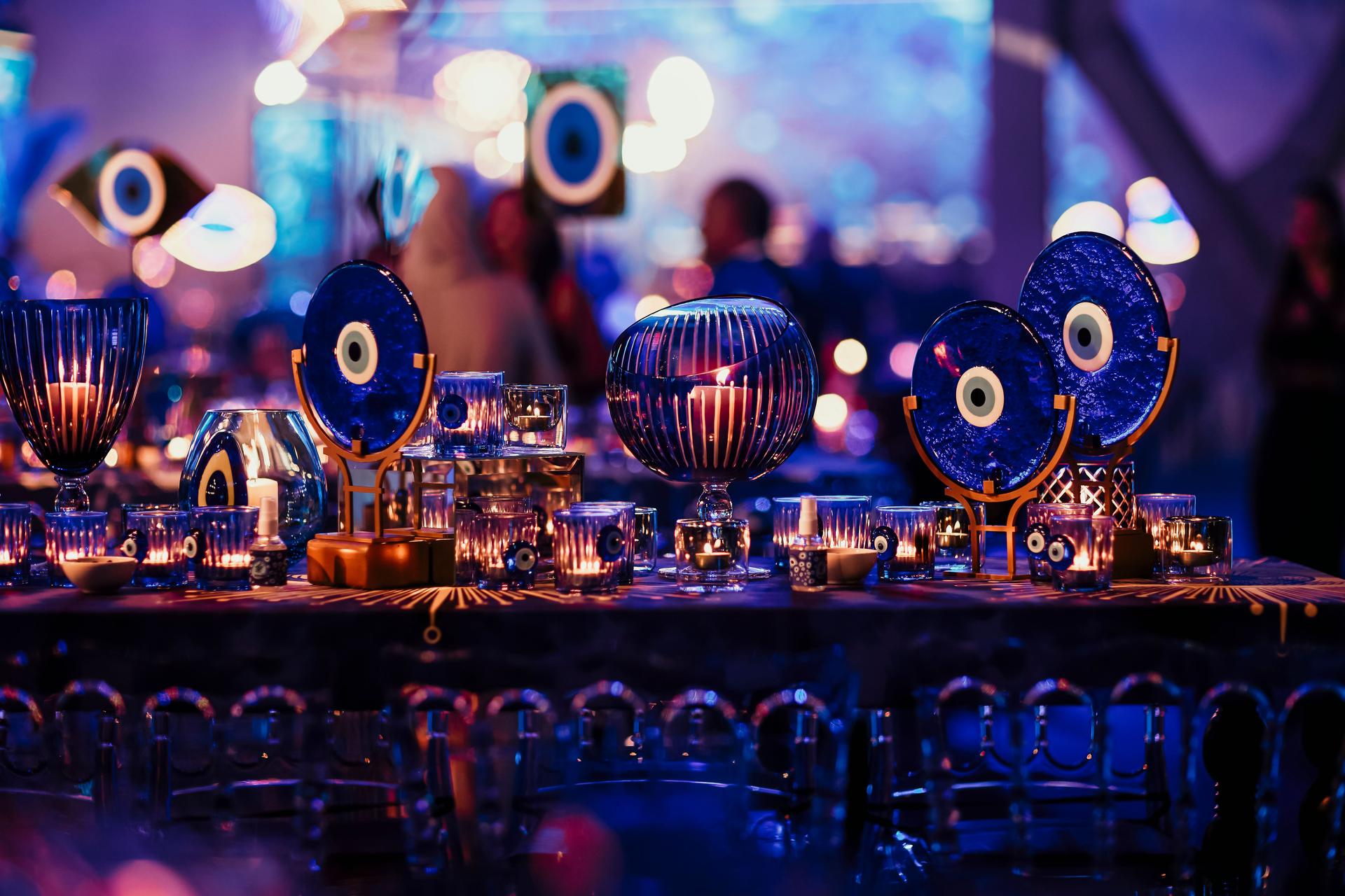 The decor details consisting of evil eye talismans and candles at the wedding reception. stock photo